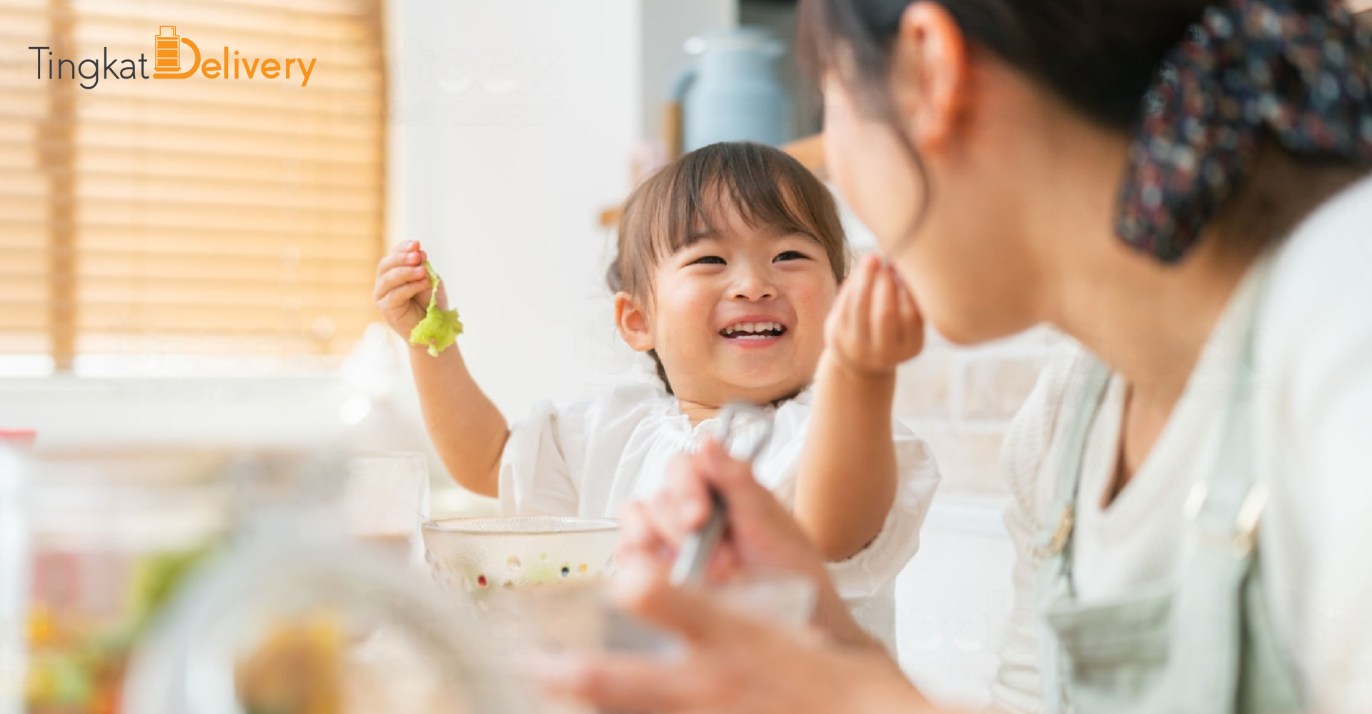 a child smile while dining with her mother